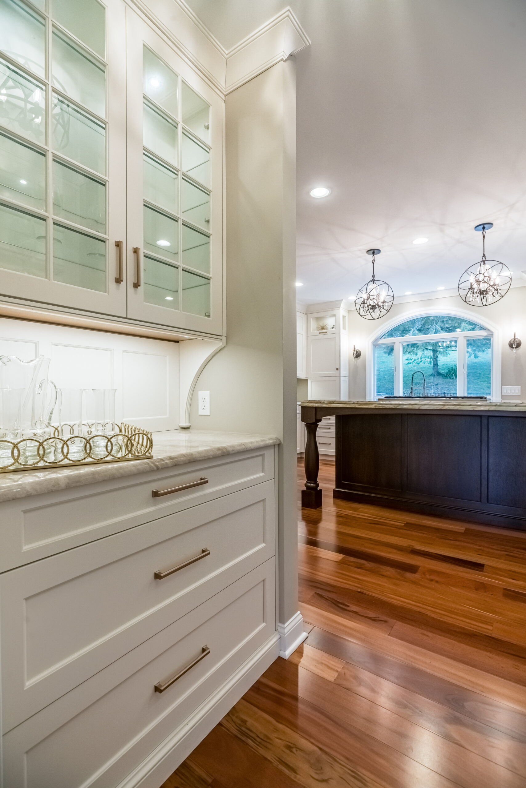 Kitchen: glass-front upper cabinets, butler pantry, built by Premier Custom Builders